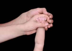 Adoption cases with child and parent hands picture